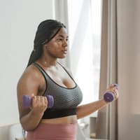 Fitness-Trend "Cozy Cardio" Frau macht "Cozy Cardio" mit Hanteln